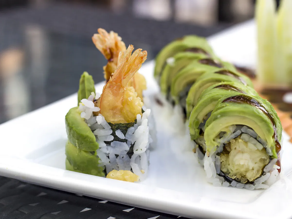 Tempura shrimp avocado sushi rolls on white plate at Love Sushi, a Japanese Restaurant in Thornton